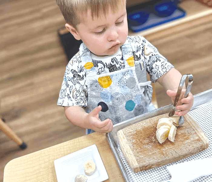 Toddler practicing a hands-on Montessori activity
